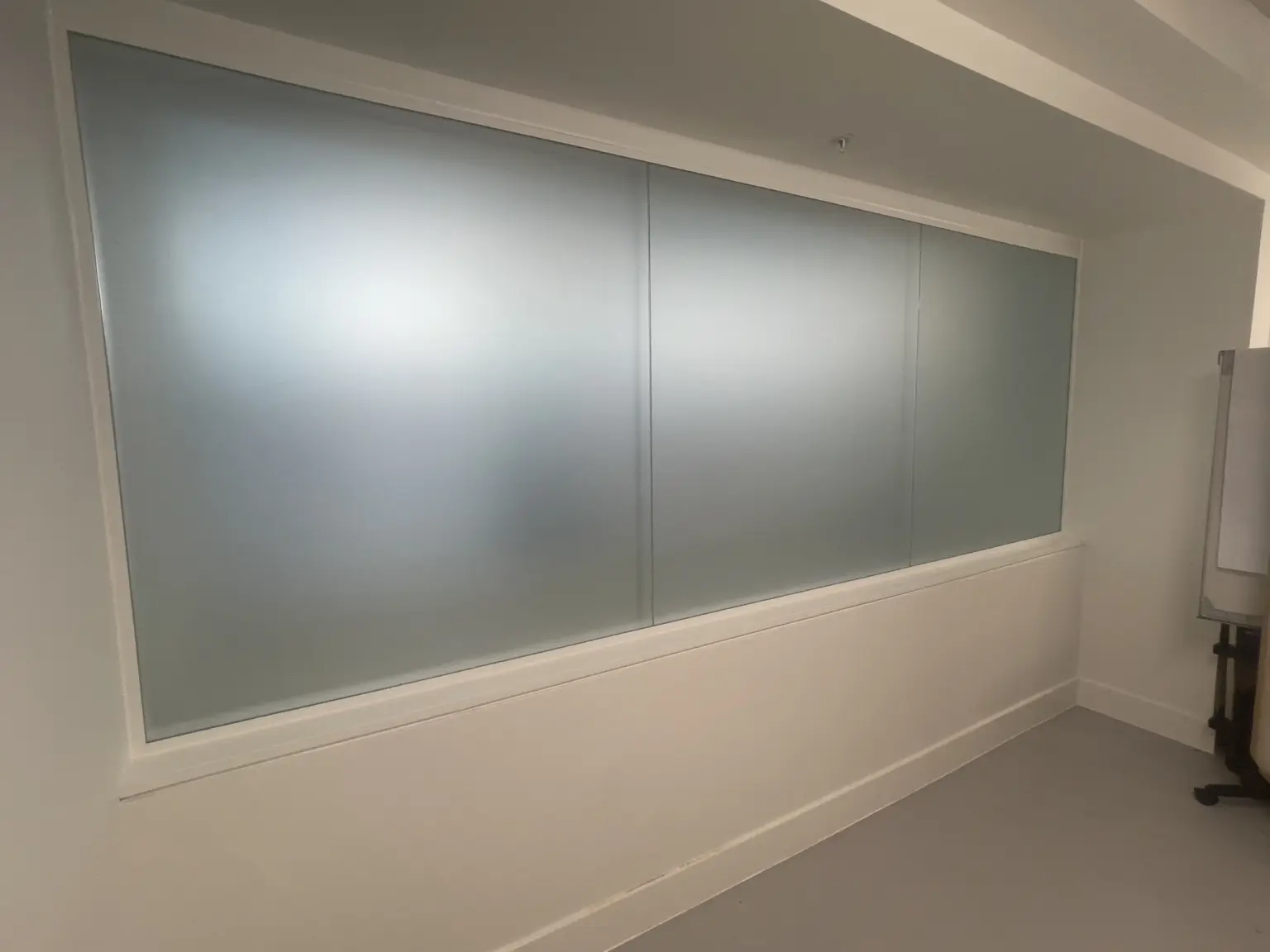 Frosted privacy film installed on an internal commercial glass partition