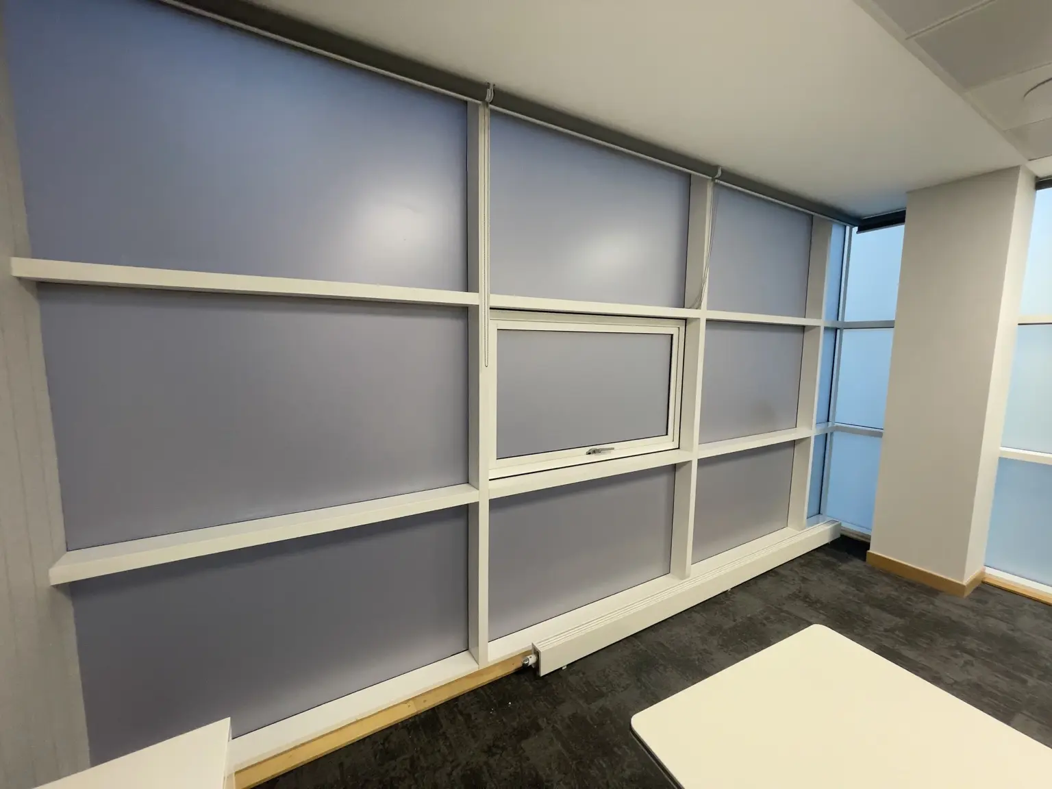 Grey privacy window film installed across a large commercial glazed wall