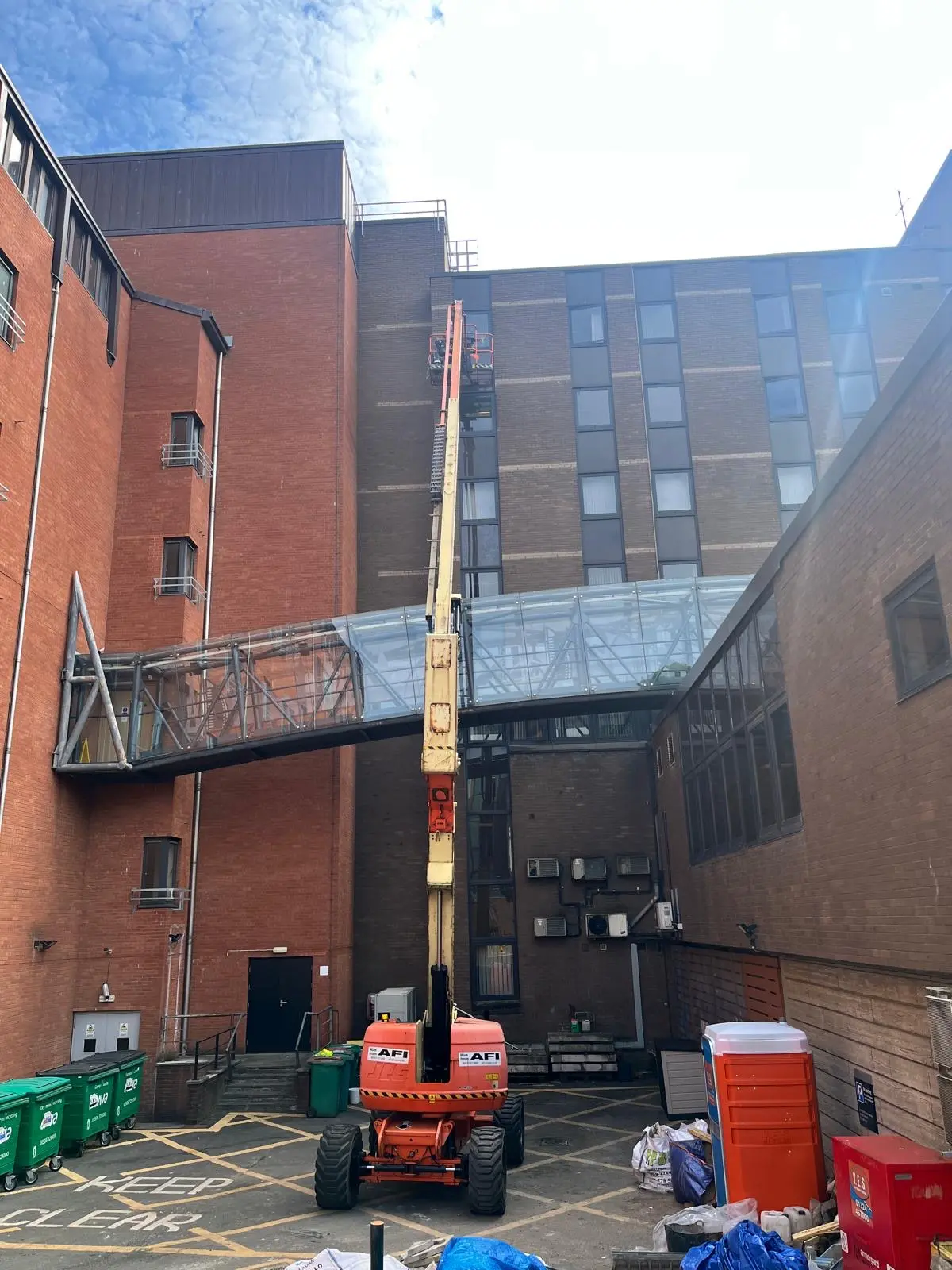 Specialist access equipment beside high-level commercial glazing